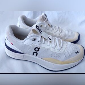 On Running White and Black Athletic Shoes